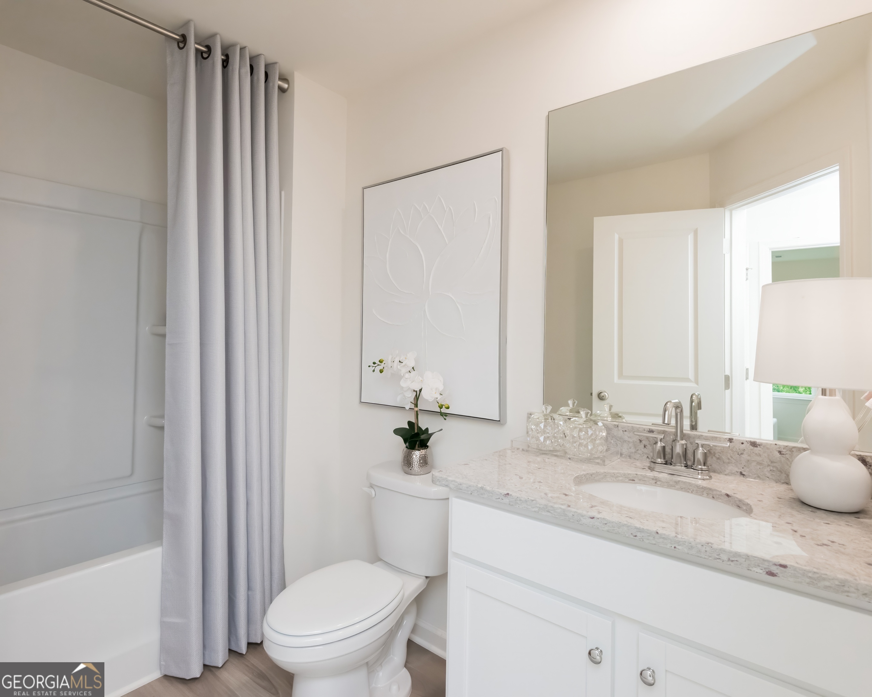 2553 Riverside Court Northeast Conyers, GA 30013 - Photo 32 of 40 a bathroom with a granite countertop sink mirror vanity and toilet