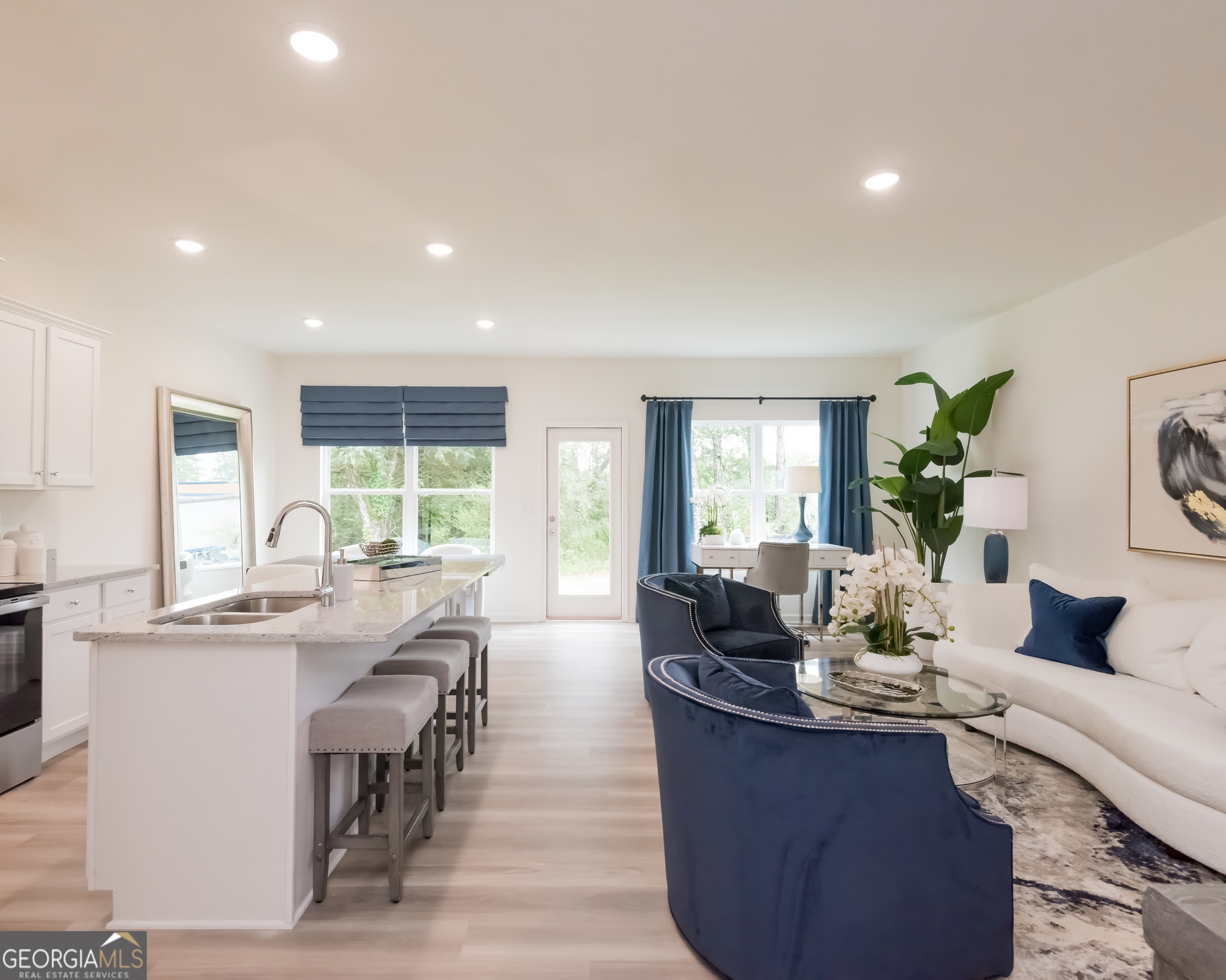2553 Riverside Court Northeast Conyers, GA 30013 - Photo 7 of 40 a view of a dining room with furniture a potted plant and wooden floor