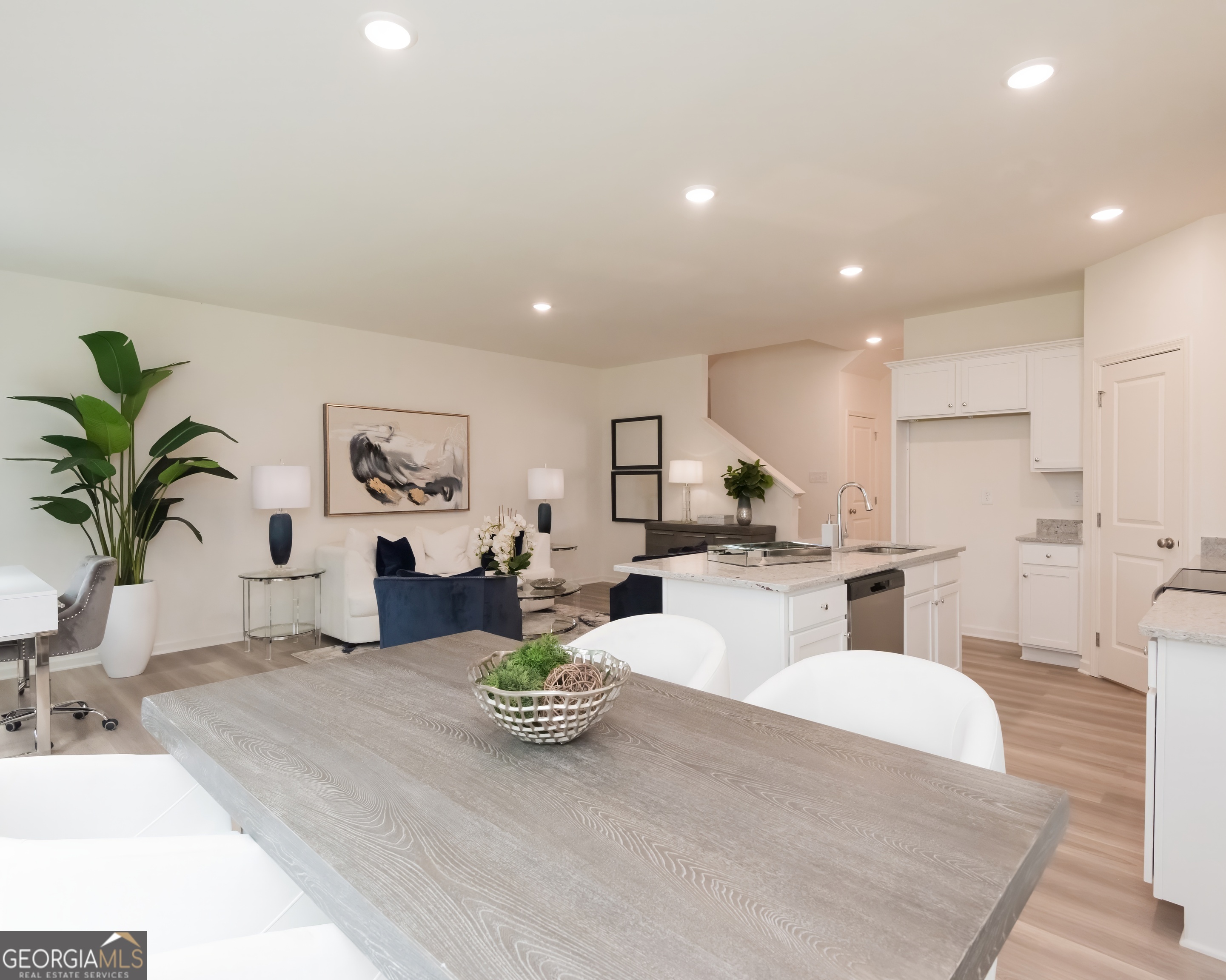 2553 Riverside Court Northeast Conyers, GA 30013 - Photo 9 of 40 a living room with furniture kitchen view and a potted plant