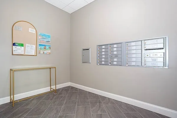 an empty room with windows and mirror