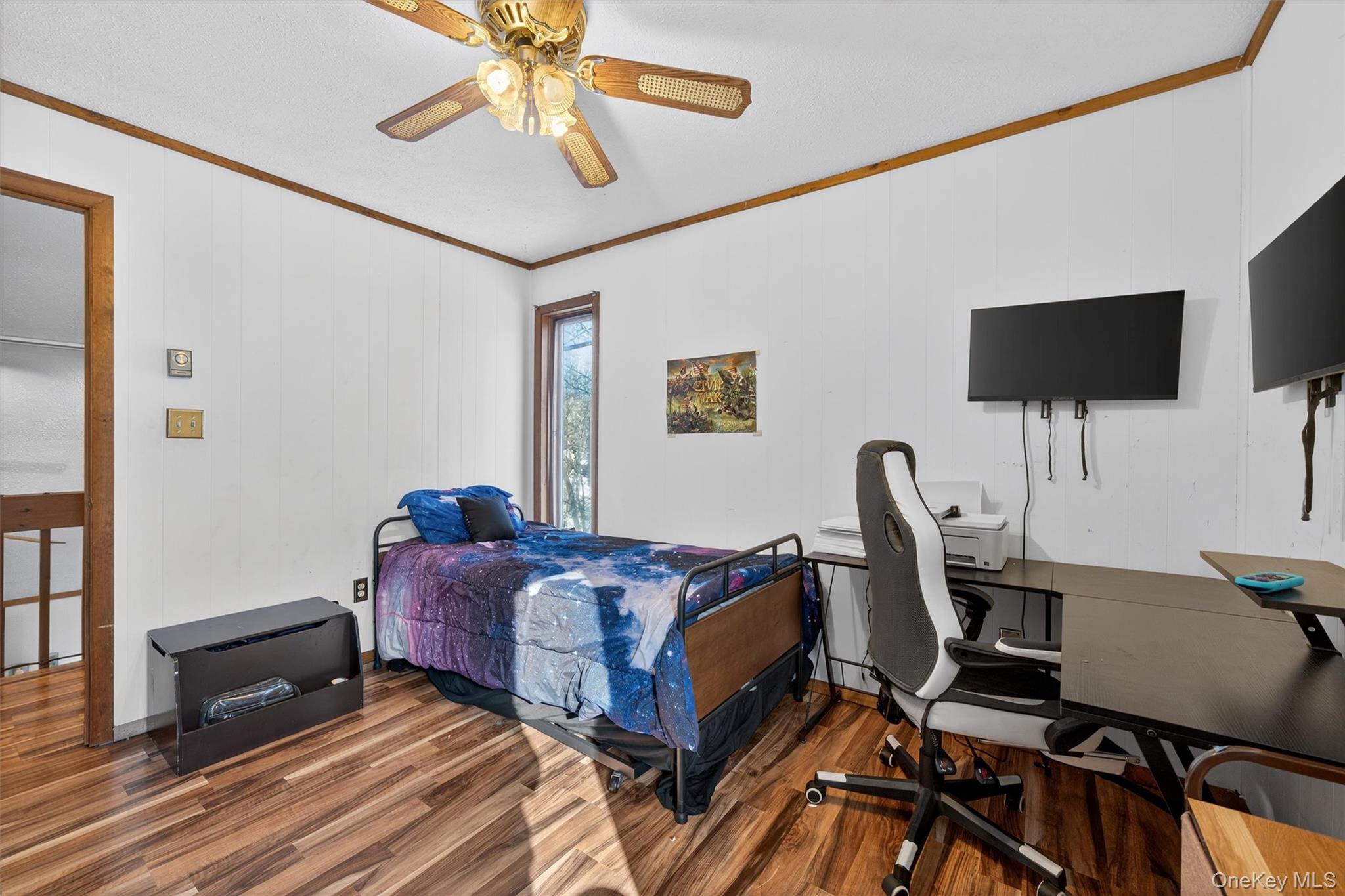 3111 Cherry Ridge Road Bushkill, PA 18324 - Photo 24 of 29 Bedroom featuring ornamental molding, wood finished floors, ceiling fan, and a desk