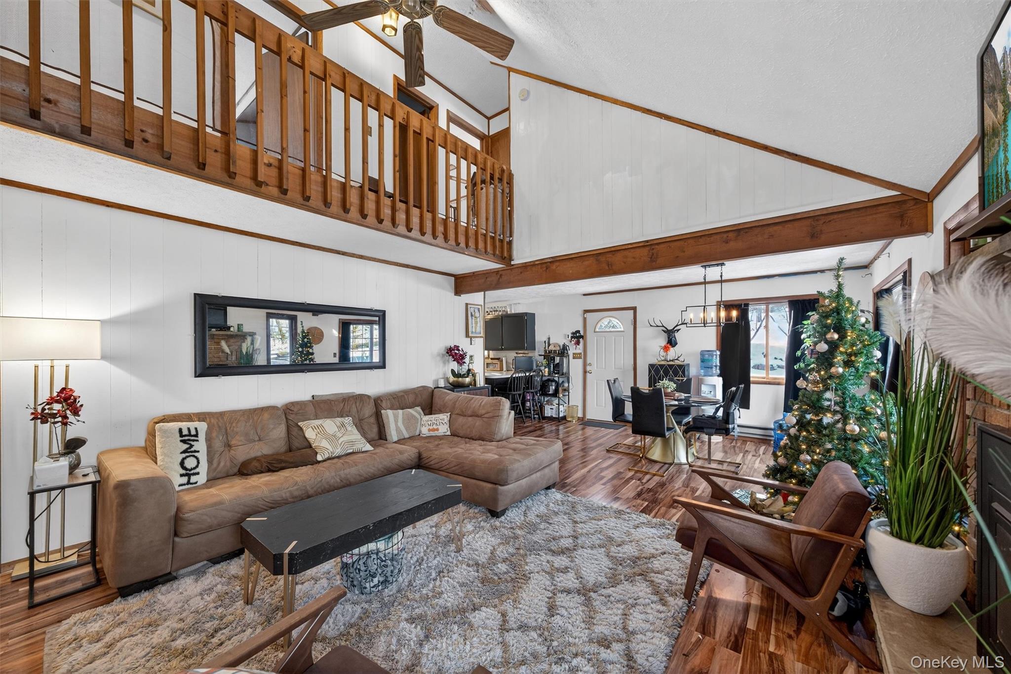 3111 Cherry Ridge Road Bushkill, PA 18324 - Photo 9 of 29 Living area featuring wood finished floors, wood walls, a ceiling fan, and high vaulted ceiling
