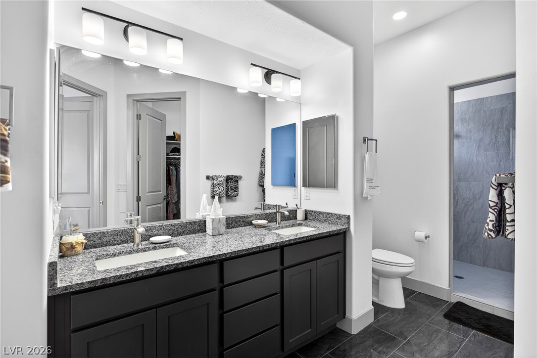 1460 Blue Ridge Trail Mesquite, NV 89027 - Photo 20 of 39 Granite counters and dual sinks define this sleek, well-lit primary bathroom.