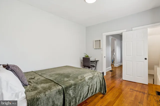 a bed room with a bed and a night stand