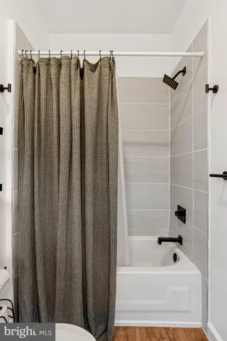 a bathroom with a shower and a bath tub