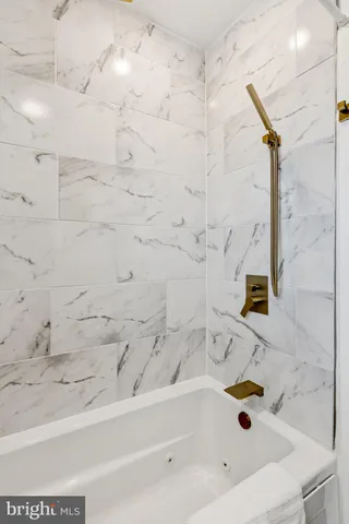 a bathroom with bathtub and shower