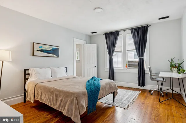 a bed room with a bed and a chair