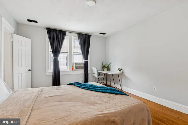 a bedroom with a bed and a large window