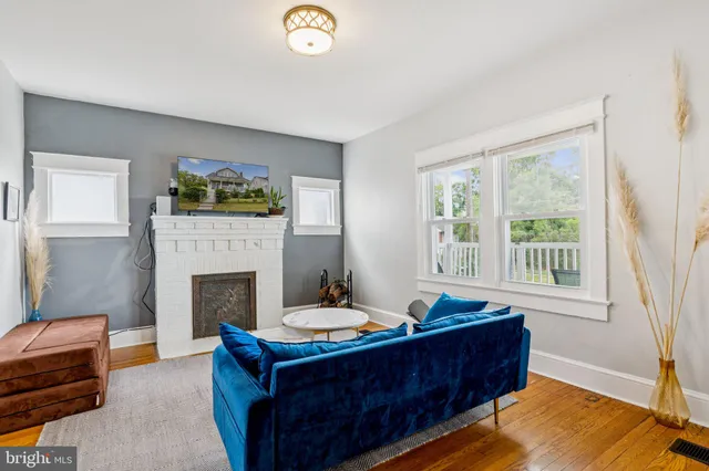 a living room with furniture and a fireplace