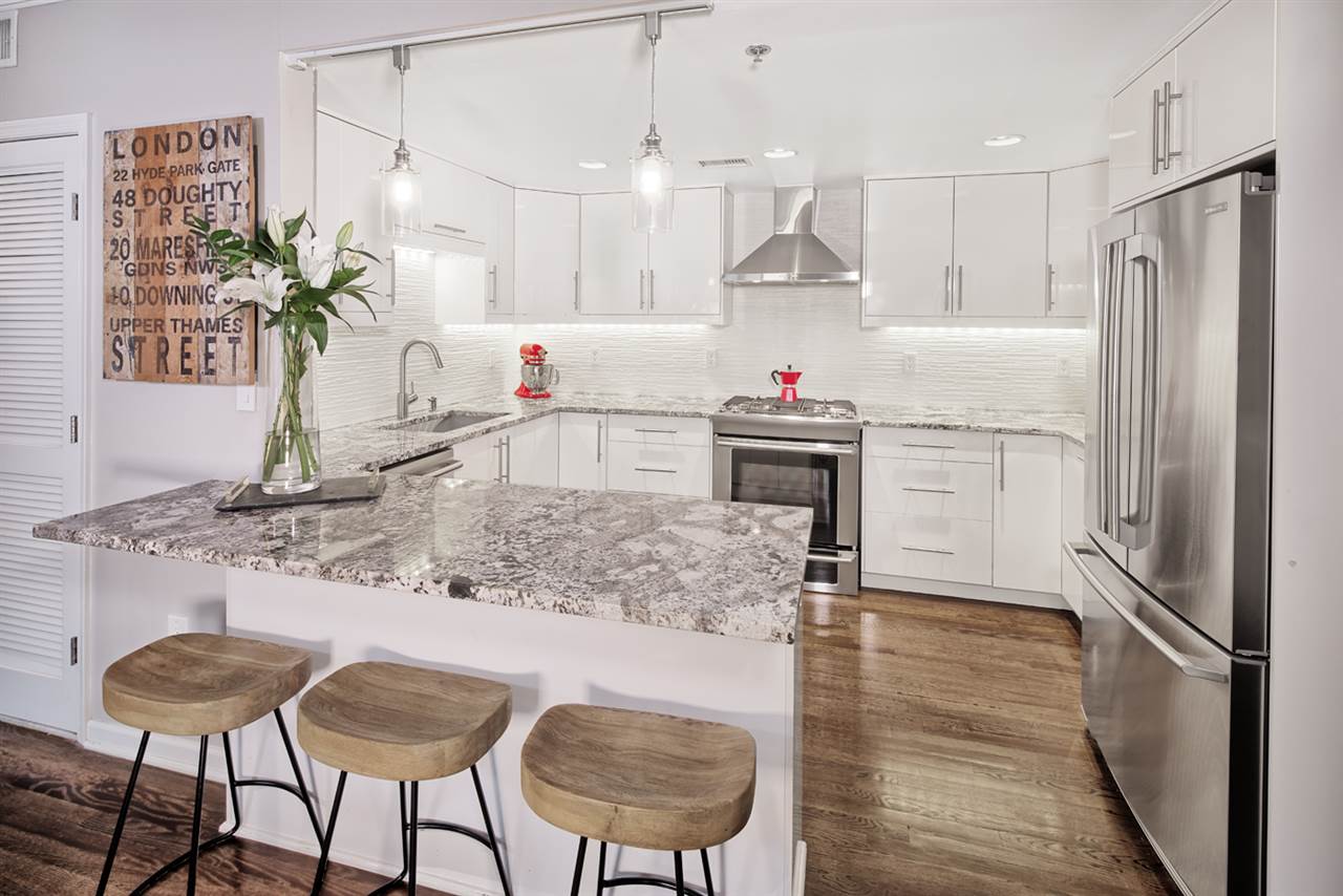 77 Jefferson Street, Unit 7 Hoboken, NJ 07030 - Photo 1 of 1 a kitchen with kitchen island a counter top space a sink stainless steel appliances and cabinets