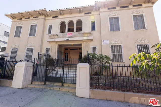a view of a white building with many windows