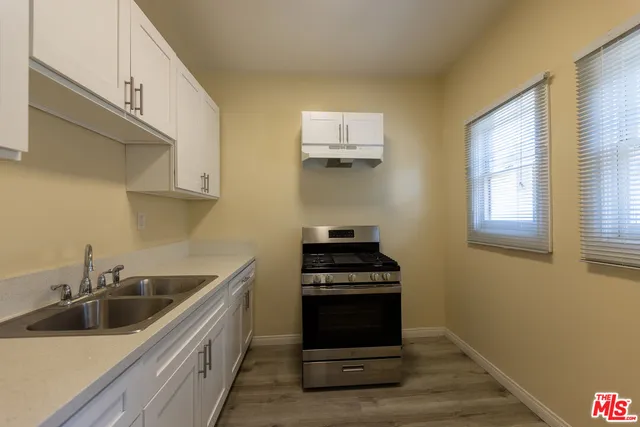a kitchen that has a sink and a stove