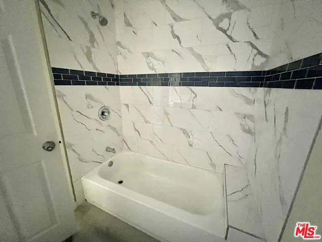 a bathroom with a shower and a window