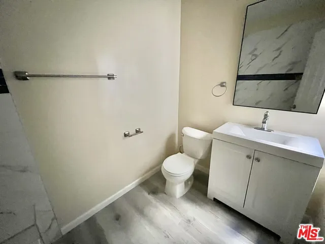 a bathroom with a sink mirror vanity and toilet