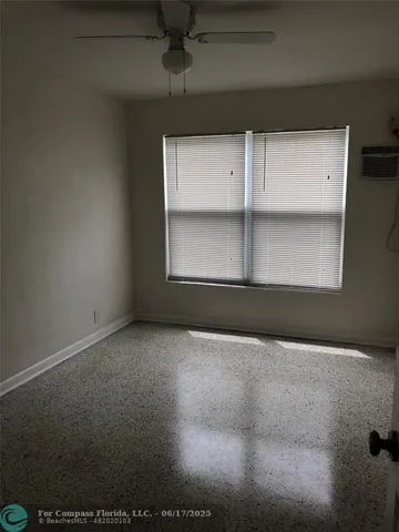a view of an empty room with a window