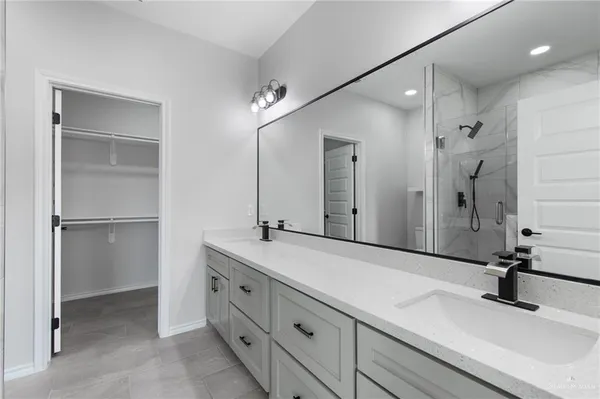 a bathroom with a double vanity sink mirror and double