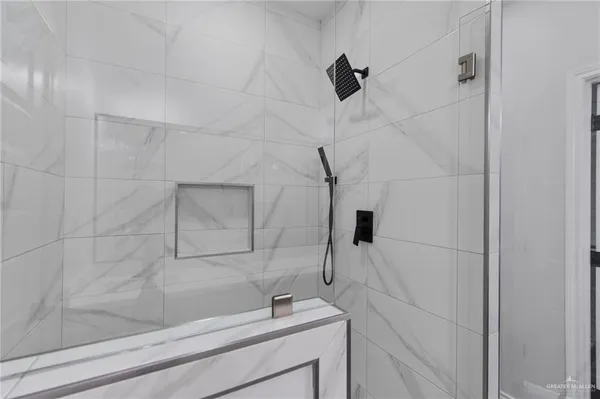 a bathroom with a bathtub and shower