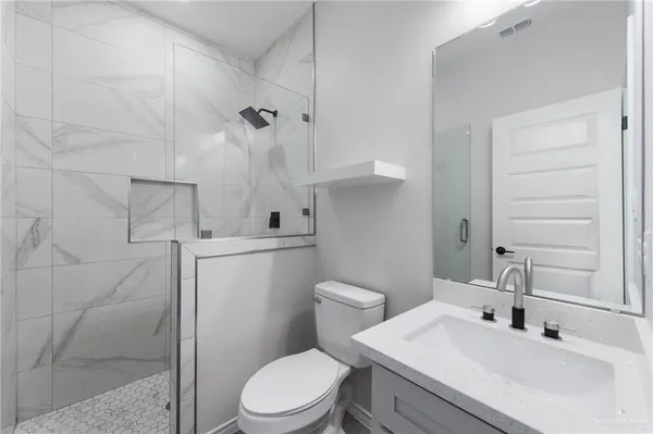 a bathroom with a sink toilet and shower
