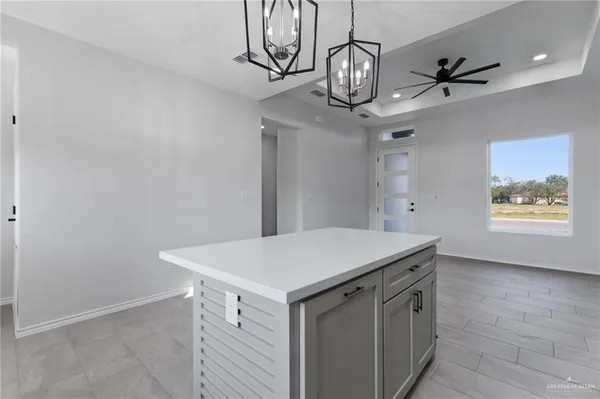 a view of a hallway with chandelier