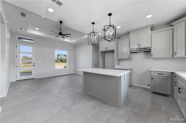 a view of a kitchen with stove and cabinets