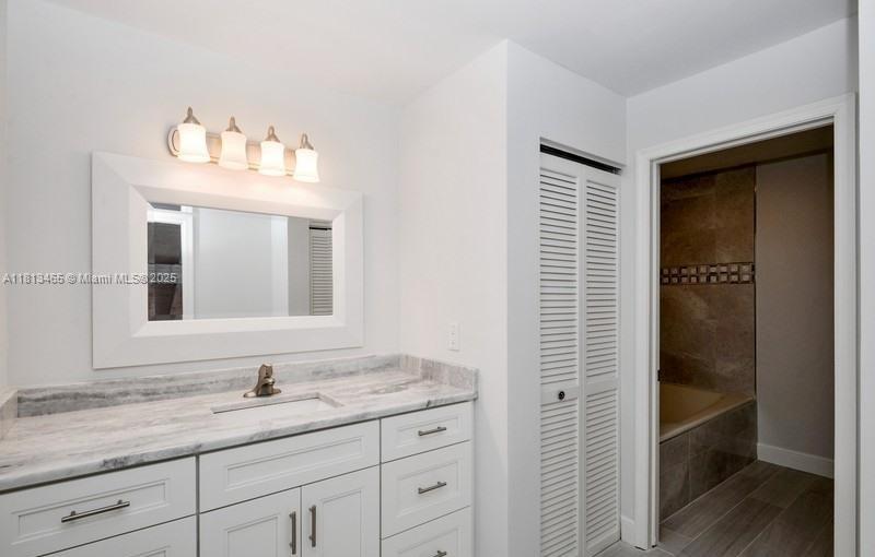 1605 Highway 1, Unit 10H Jupiter, FL 33477 - Photo 12 of 31 a bathroom with a granite countertop sink and a mirror