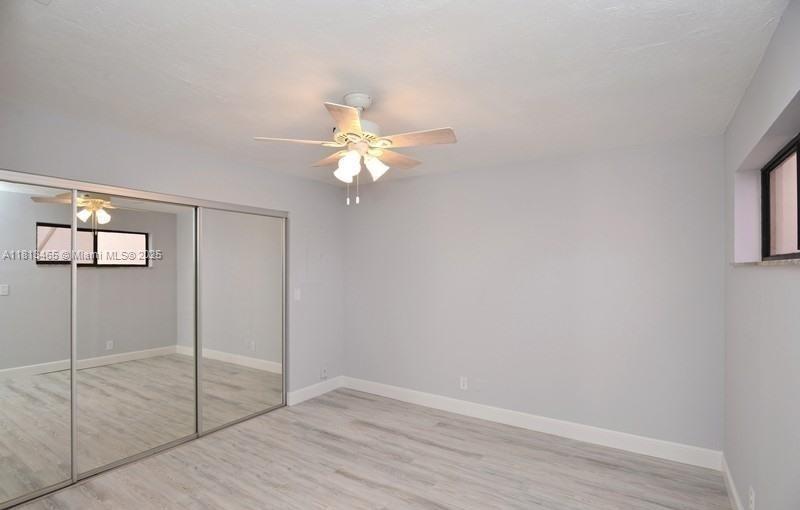 1605 Highway 1, Unit 10H Jupiter, FL 33477 - Photo 13 of 31 a view of a room with wooden floor and fan