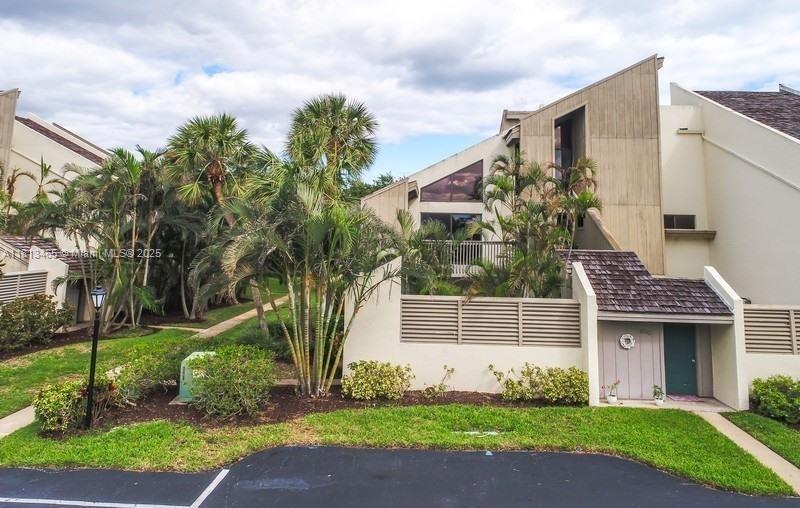 1605 Highway 1, Unit 10H Jupiter, FL 33477 - Photo 26 of 31 a front view of a house with garden