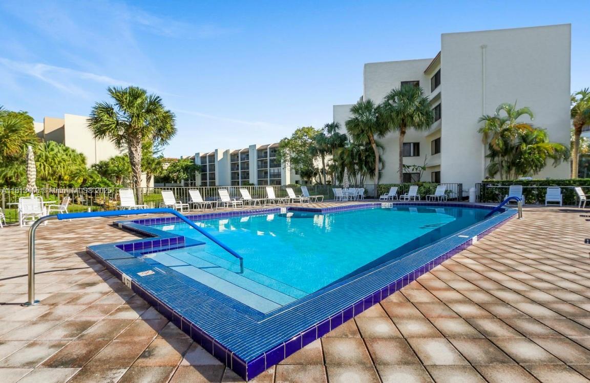 1605 Highway 1, Unit 10H Jupiter, FL 33477 - Photo 28 of 31 a view of a tennis ground with large trees