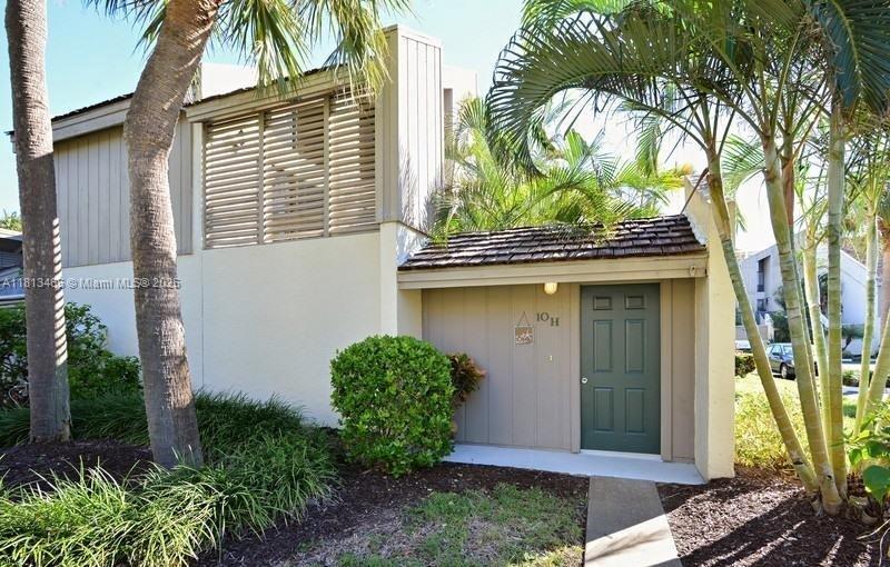 1605 Highway 1, Unit 10H Jupiter, FL 33477 - Photo 3 of 31 a front view of a house with garden