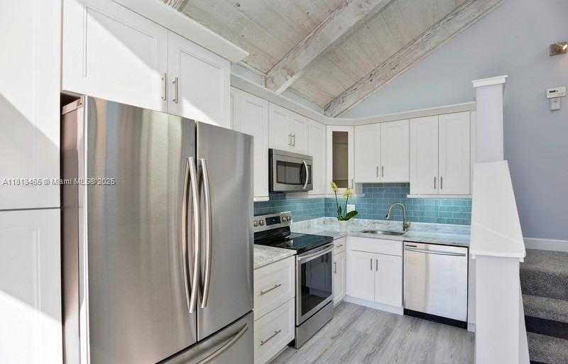1605 Highway 1, Unit 10H Jupiter, FL 33477 - Photo 7 of 31 a kitchen with a refrigerator sink and microwave