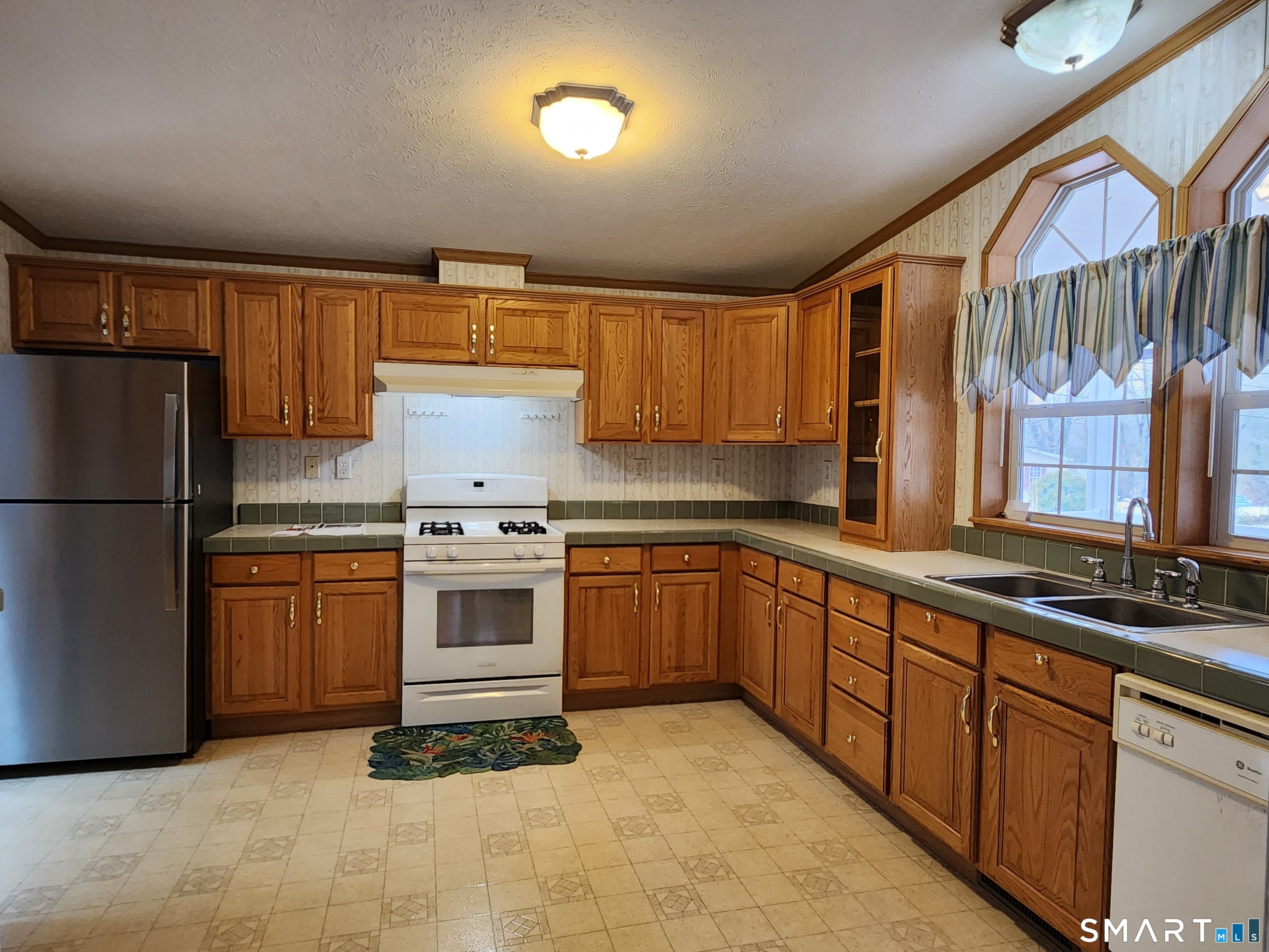 43 Evergreen Park Clinton, CT 06413 - Photo 13 of 43 a kitchen with stainless steel appliances granite countertop a stove a sink and a refrigerator