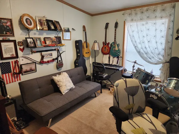 a living room with furniture a rug and a wall painting