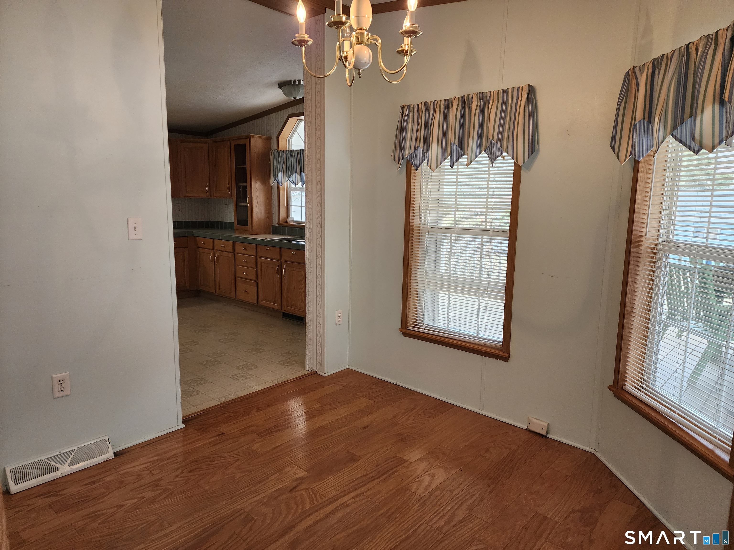 43 Evergreen Park Clinton, CT 06413 - Photo 17 of 43 a view of a kitchen and an empty room with a window