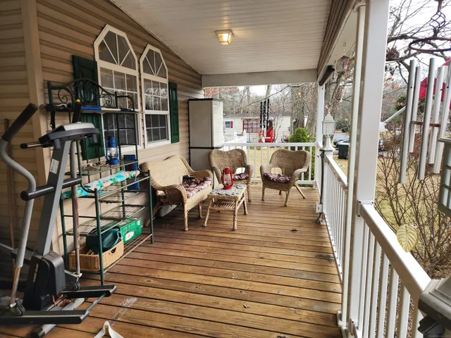 a view of a patio with dining table and chairs