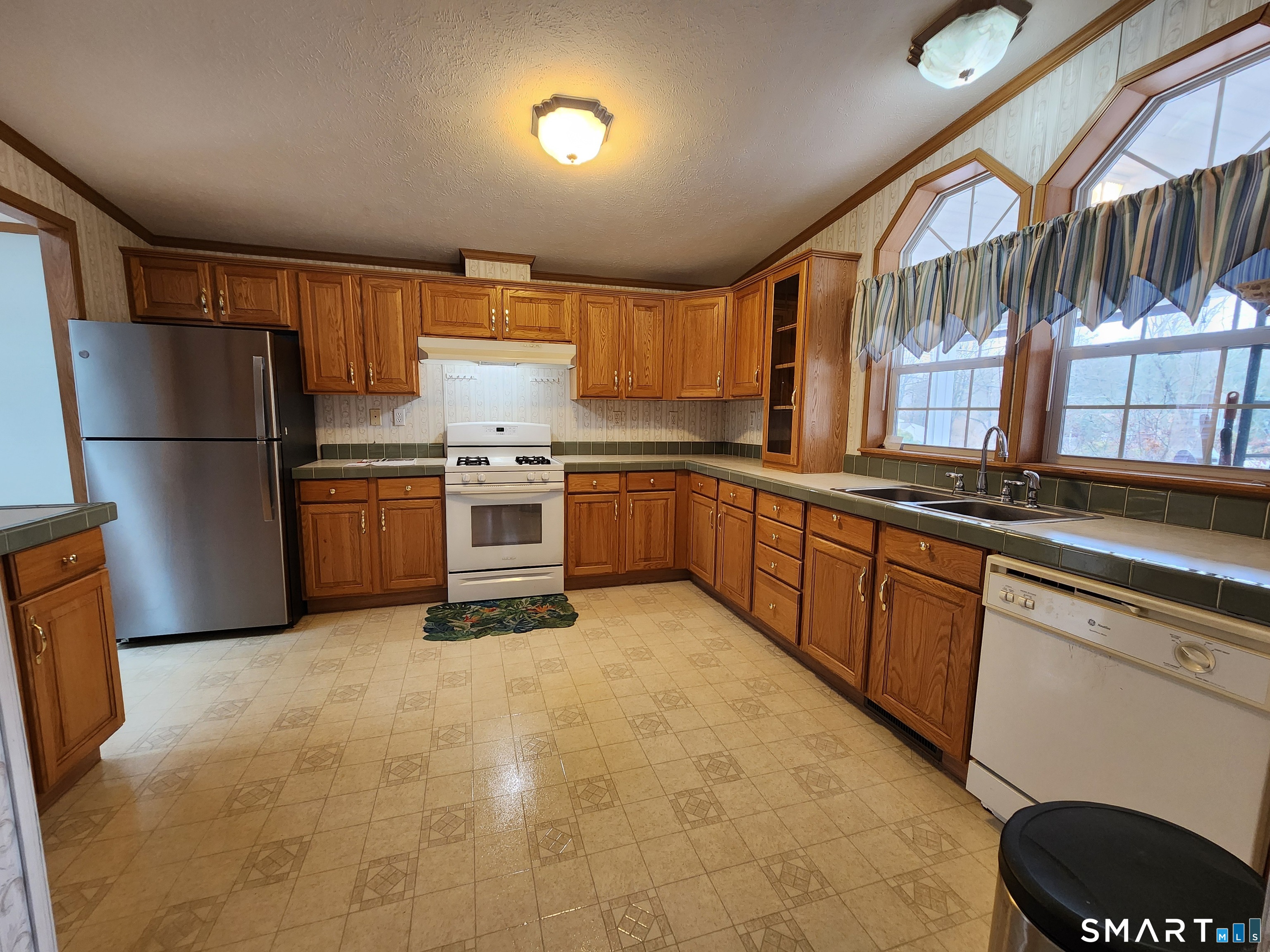 43 Evergreen Park Clinton, CT 06413 - Photo 3 of 43 a kitchen with stainless steel appliances granite countertop a refrigerator and a stove top oven