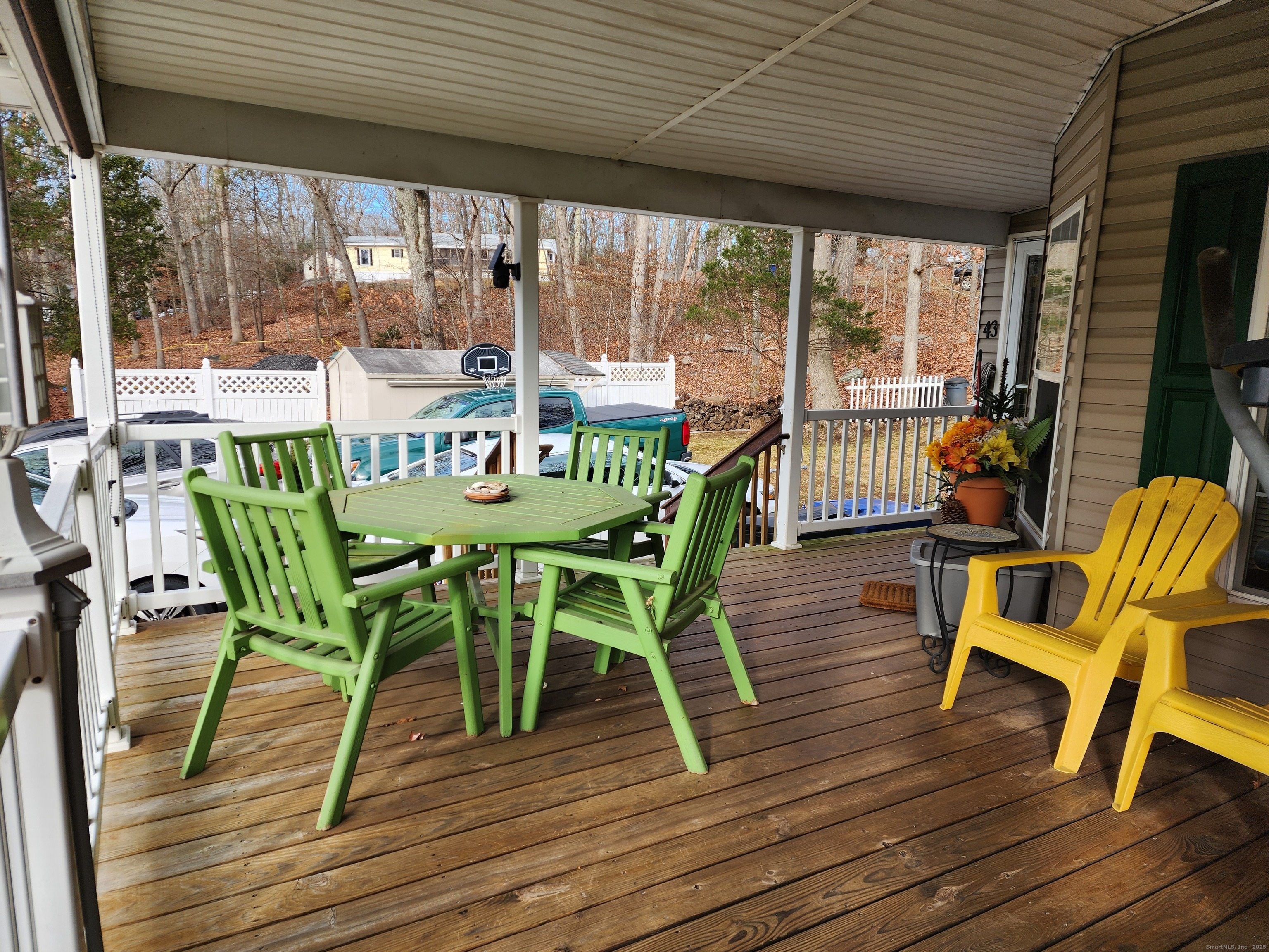 43 Evergreen Park Clinton, CT 06413 - Photo 38 of 43 a view of a patio with table and chairs and wooden floor