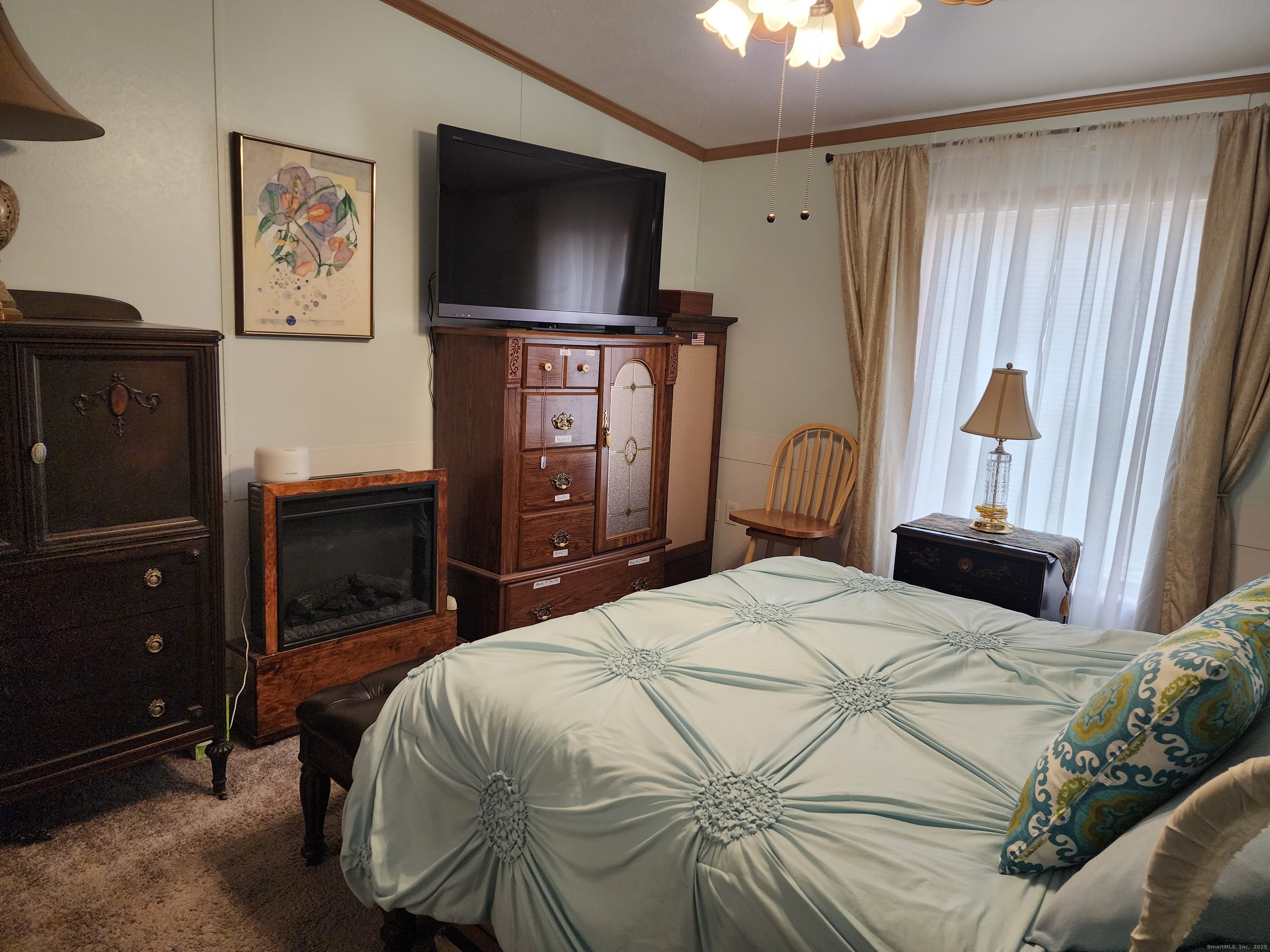 43 Evergreen Park Clinton, CT 06413 - Photo 39 of 43 a bedroom with a bed and a television