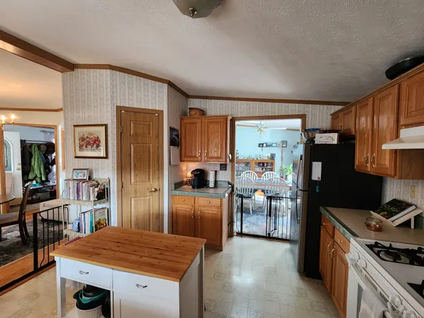 a kitchen with stainless steel appliances granite countertop a refrigerator oven stove a sink and dishwasher