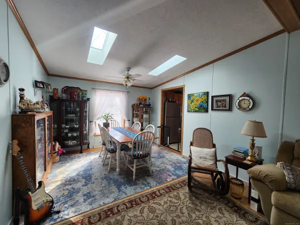 a dining room with furniture and a window