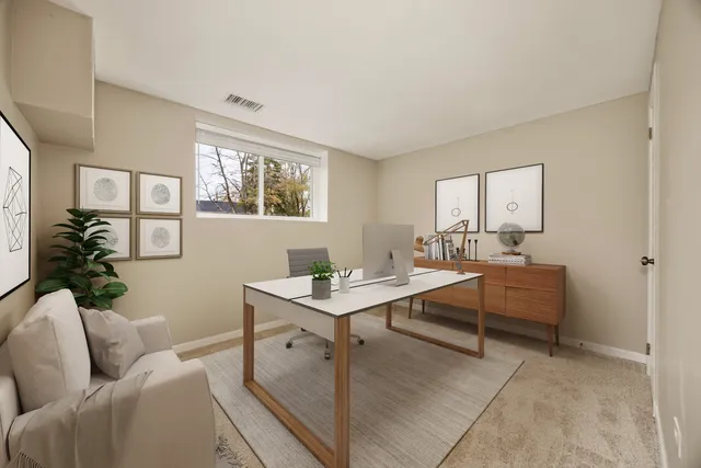a living room with furniture a desk and chair with wooden floor