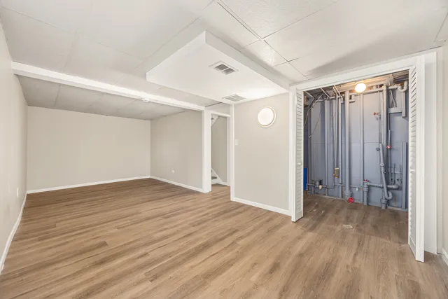 a view of an empty room with wooden floor