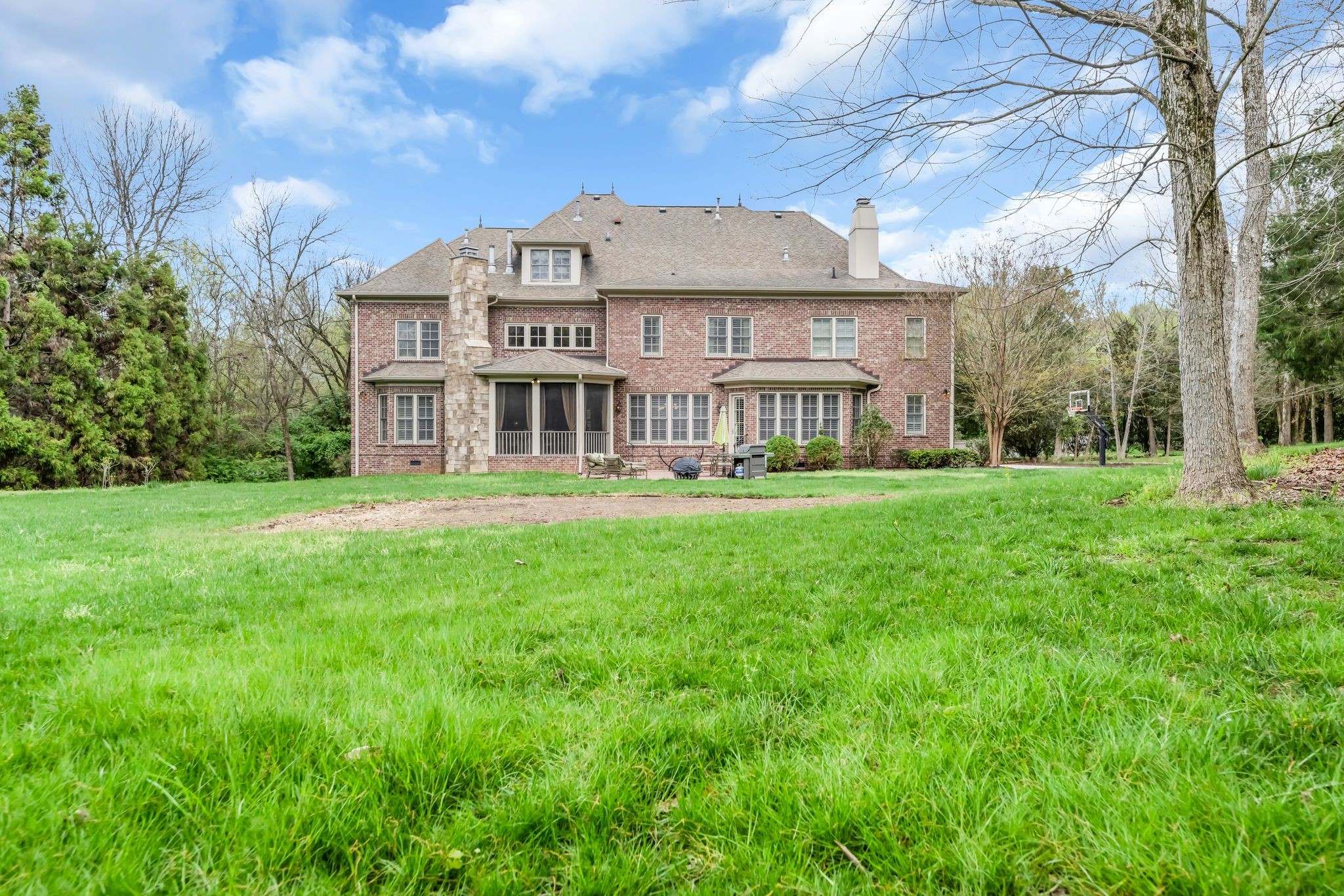 1191 Waterstone Boulevard Franklin, TN 37069 - Photo 30 of 32 a front view of a house with a yard table and chairs