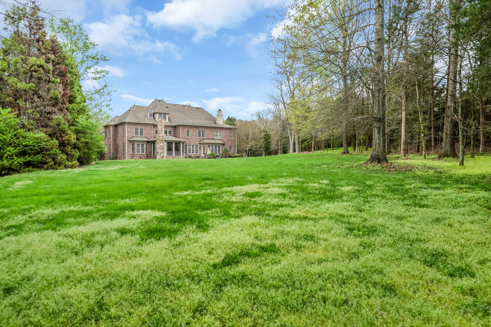 1191 Waterstone Boulevard Franklin, TN 37069 - Photo 31 of 32 a view of a house next to a big yard and large trees