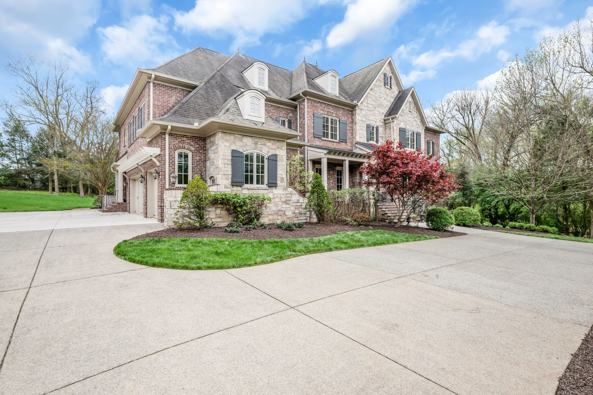1191 Waterstone Boulevard Franklin, TN 37069 - Photo 4 of 32 a front view of a house with garden