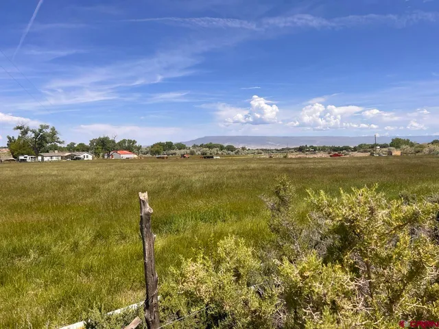 a view of a lake with sunset in the background