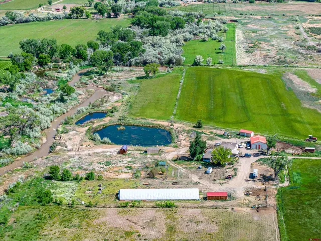 an aerial view of a house with a yard basket ball court and outdoor seating