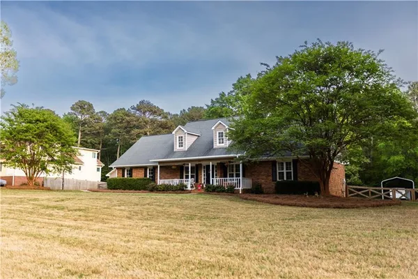 a front view of a house with a garden