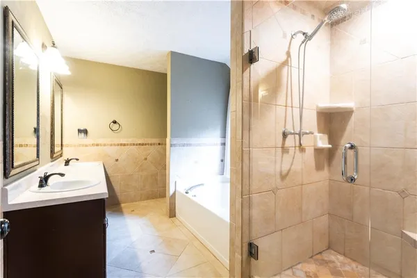 an empty room with a windows and chandelier fan