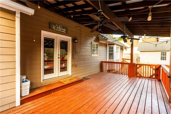 an empty room with a ceiling fan and a window