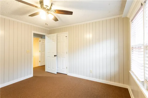 a front view of a house with a yard covered with snow